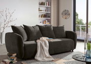 Gemütliches Funktionssofa in dunklem Stoff, seitliche Perspektive, dekoriert mit Kissen und Decke, in modernem Wohnzimmerambiente.