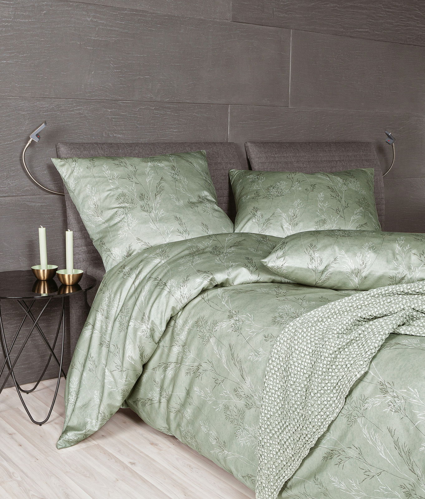 Grünes Mako-Satin Bettwäsche-Set mit floralem Muster auf einem Bett, seitliche Perspektive