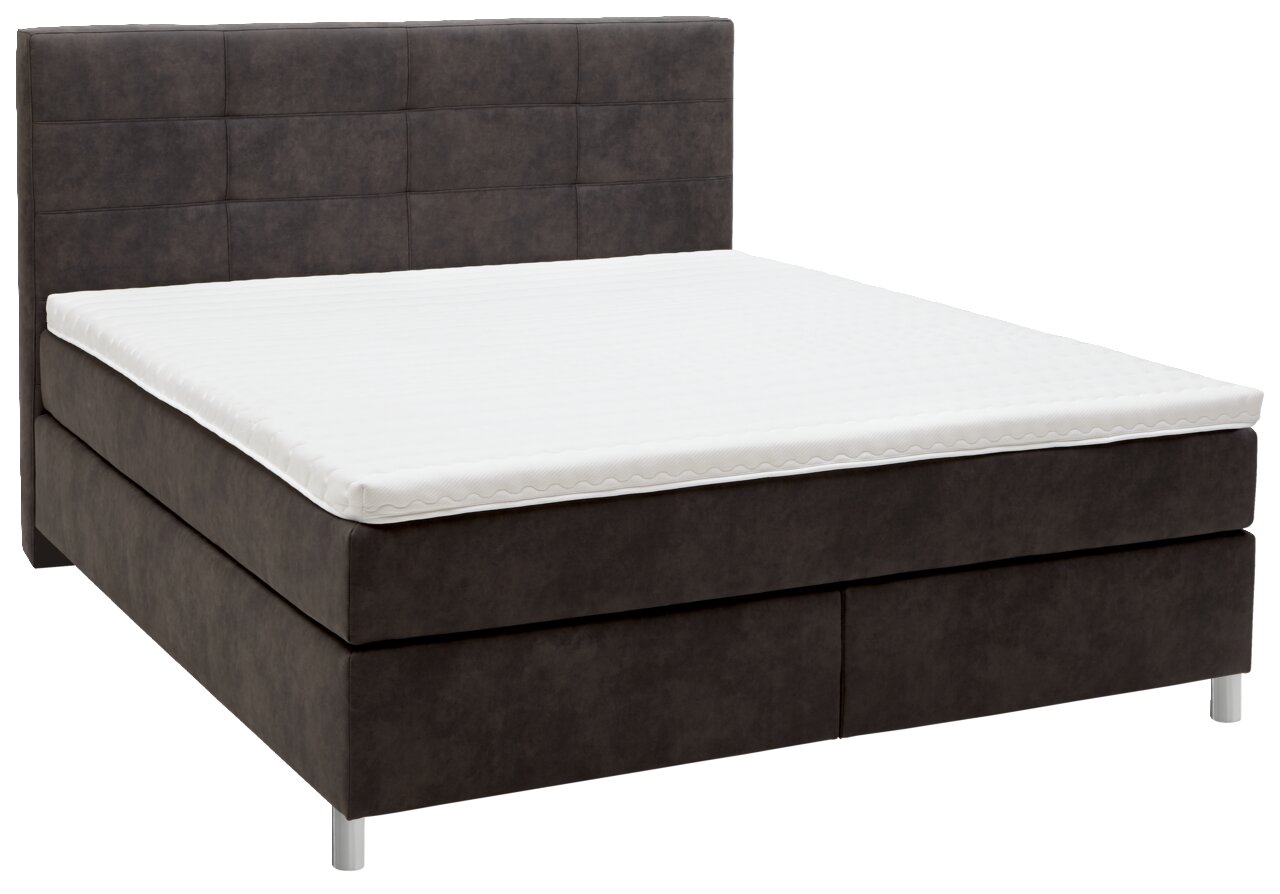 Boxspringbett in seitlicher Perspektive mit dunklem Stoffbezug und weißer Matratze