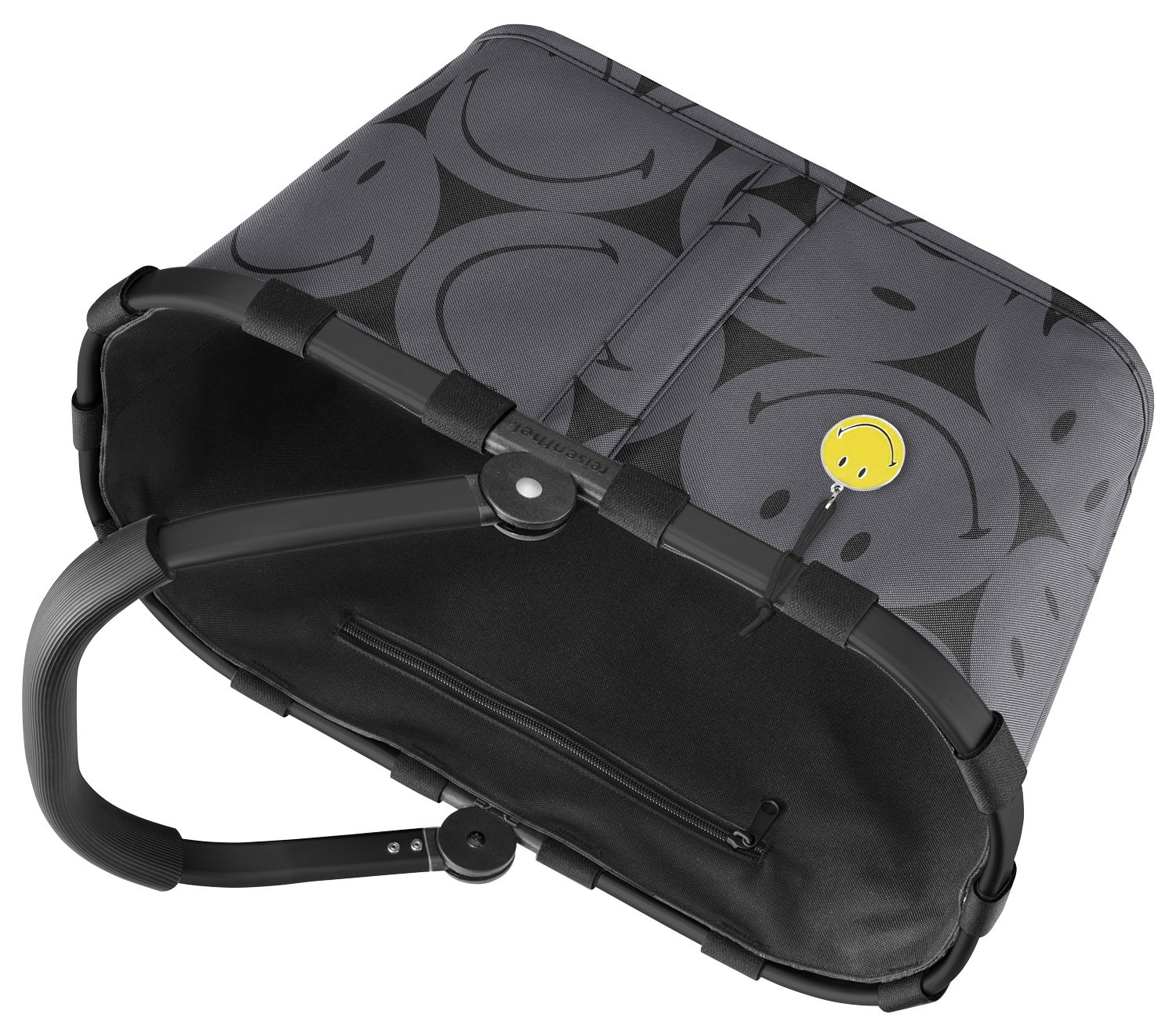 Grauer Einkaufskorb mit schwarzen Smiley-Motiven und gelbem Smiley-Anhänger, von oben betrachtet.