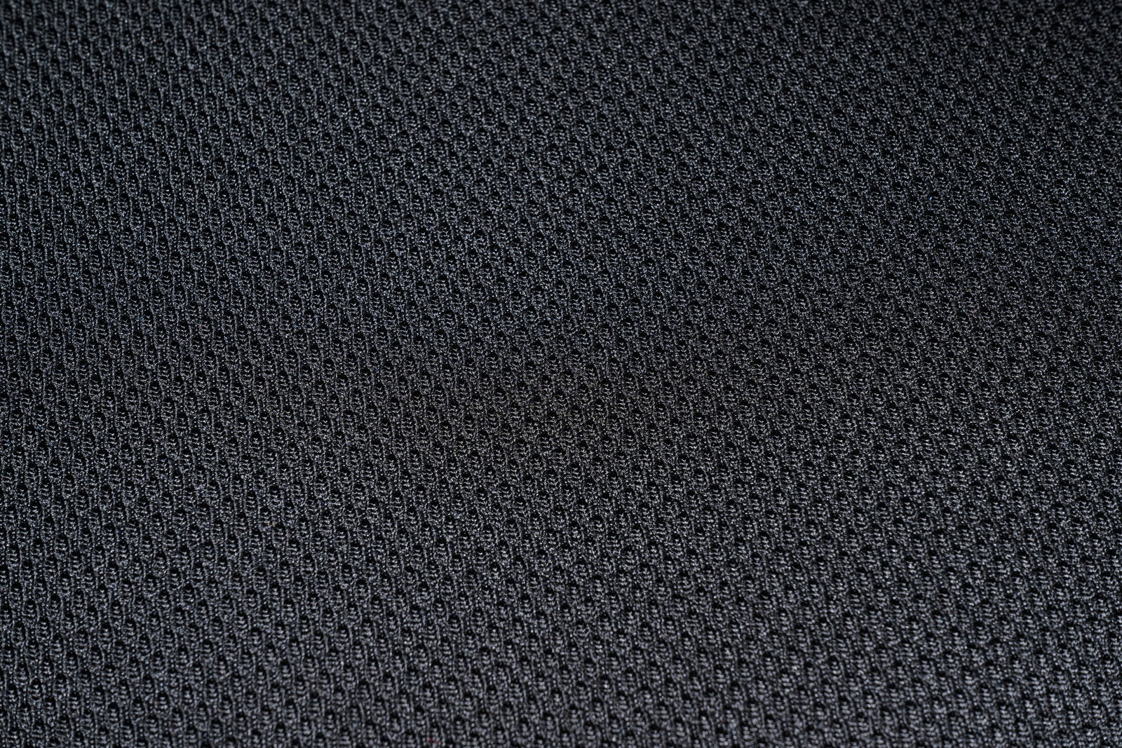 Nahaufnahme eines schwarzen Stoffmusters mit feiner Struktur