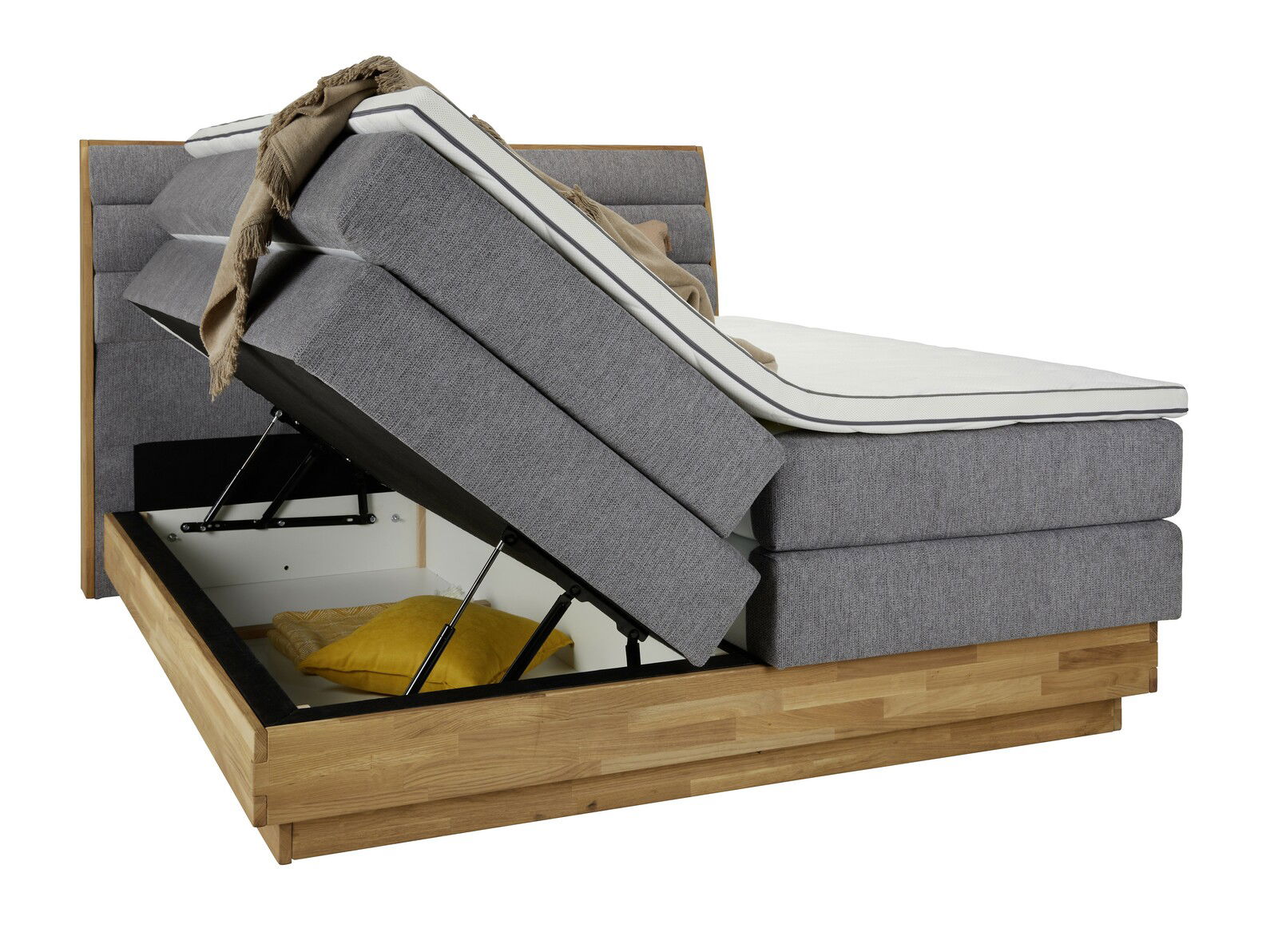 Boxspringbett mit hochgeklappter Matratze und sichtbarem Stauraum, seitliche Perspektive