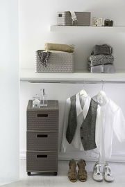 Korb A6 2 l COUNTRY in einem modernen, hellen Raum auf einem Regal, gefüllt mit Kleidung und Accessoires, seitliche Perspektive