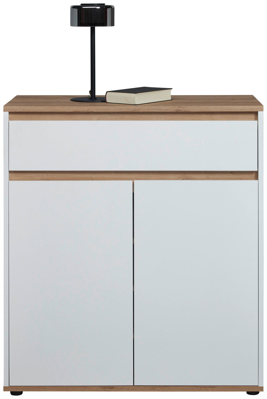 Moderne Kommode in Weiß mit Holzdetails, frontal abgebildet, mit einer schwarzen Lampe und einem Buch auf der Oberseite.