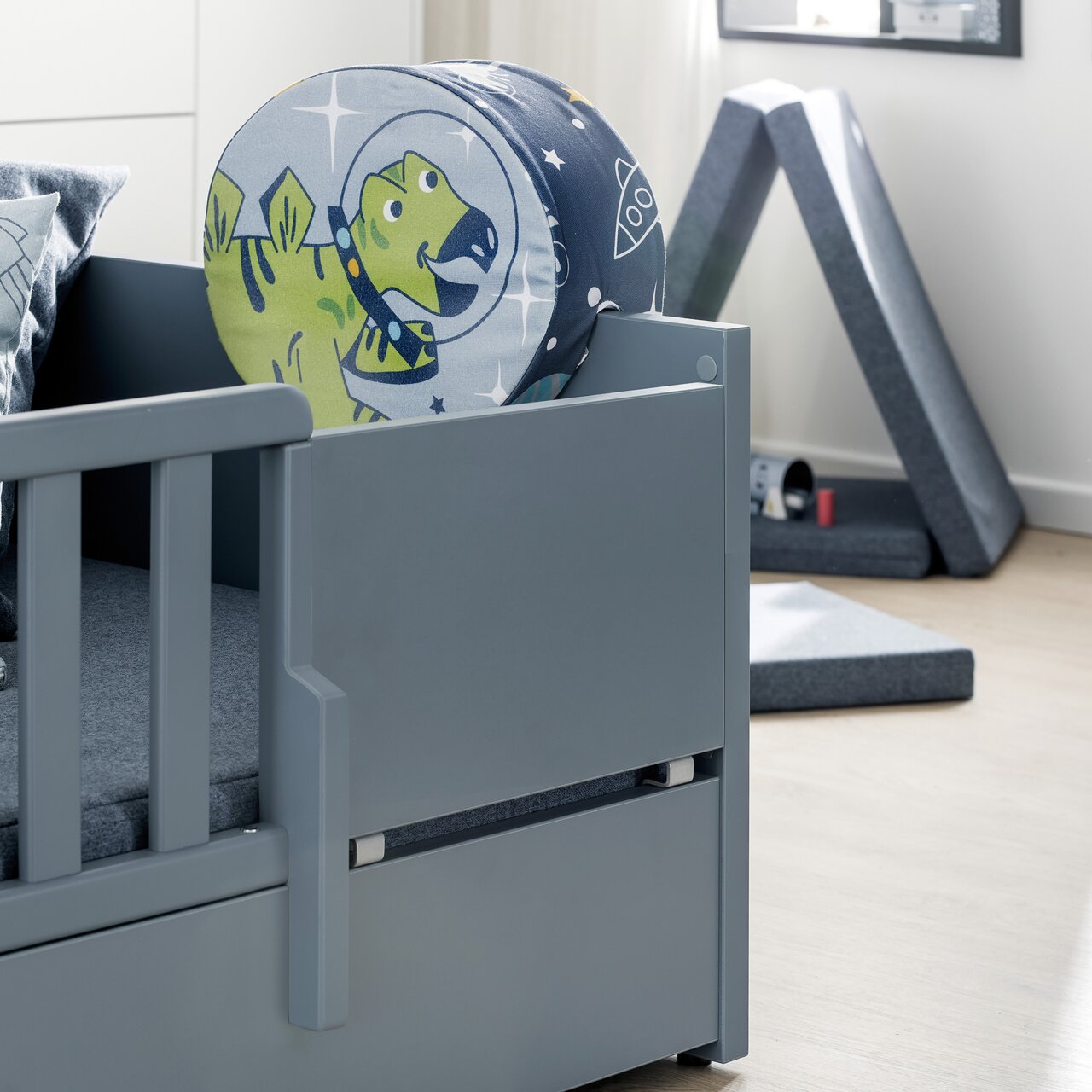 Paidi Vervangingsregeling LITTLE FLO Rausfallschutz für Kinderbett in Grau mit buntem Dinosaurier-Kissen, seitliche Perspektive