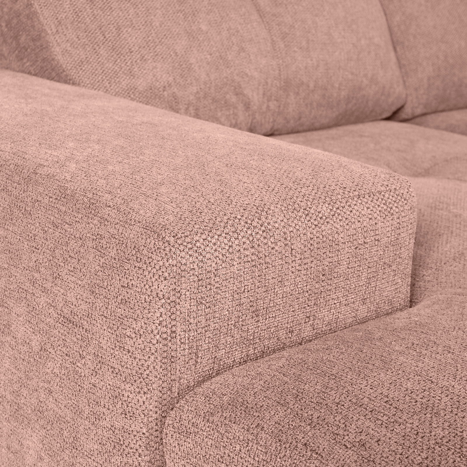 Nahaufnahme einer beigen Sofaecke mit texturierter Stoffoberfläche, Perspektive von der linken Seite.