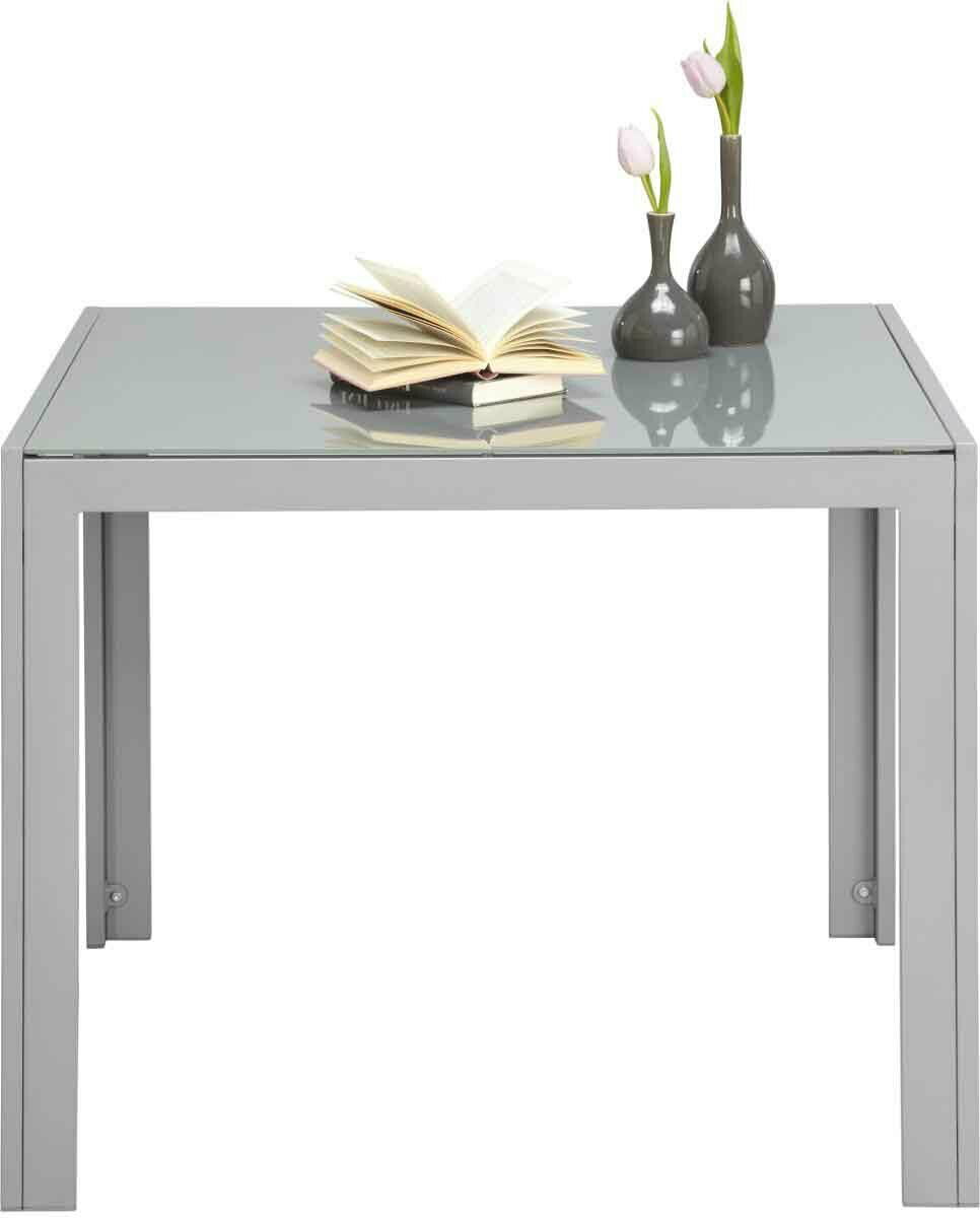 Moderner Gartentisch aus Glas und Metall mit zwei Vasen und einem offenen Buch, Frontalansicht