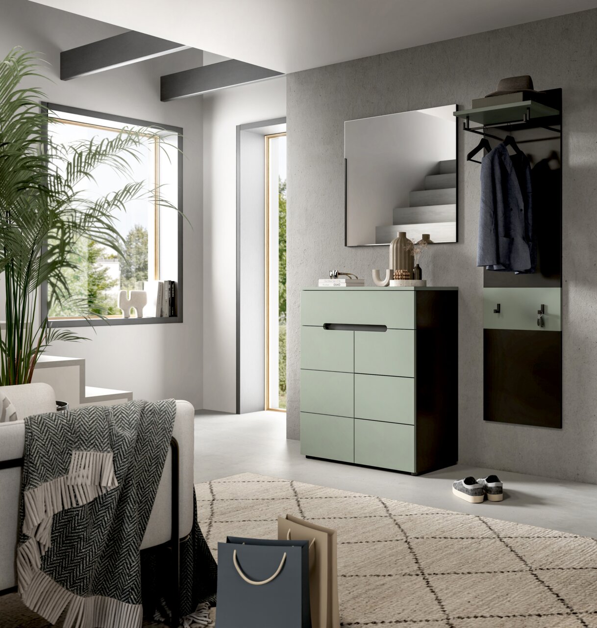 Modernes Flur-Set mit mintgrüner Kommode, Wandspiegel und Garderobenpaneel mit Kleiderstange und Haken an grauer Betonwand, seitliche Perspektive im hellen Eingangsbereich