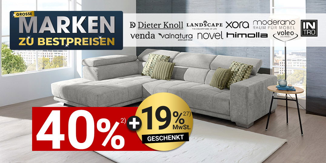 Modernes Wohnzimmer mit grauem Ecksofa, Kissen, Teppich und Markenhinweis „Große Marken zu Bestpreisen