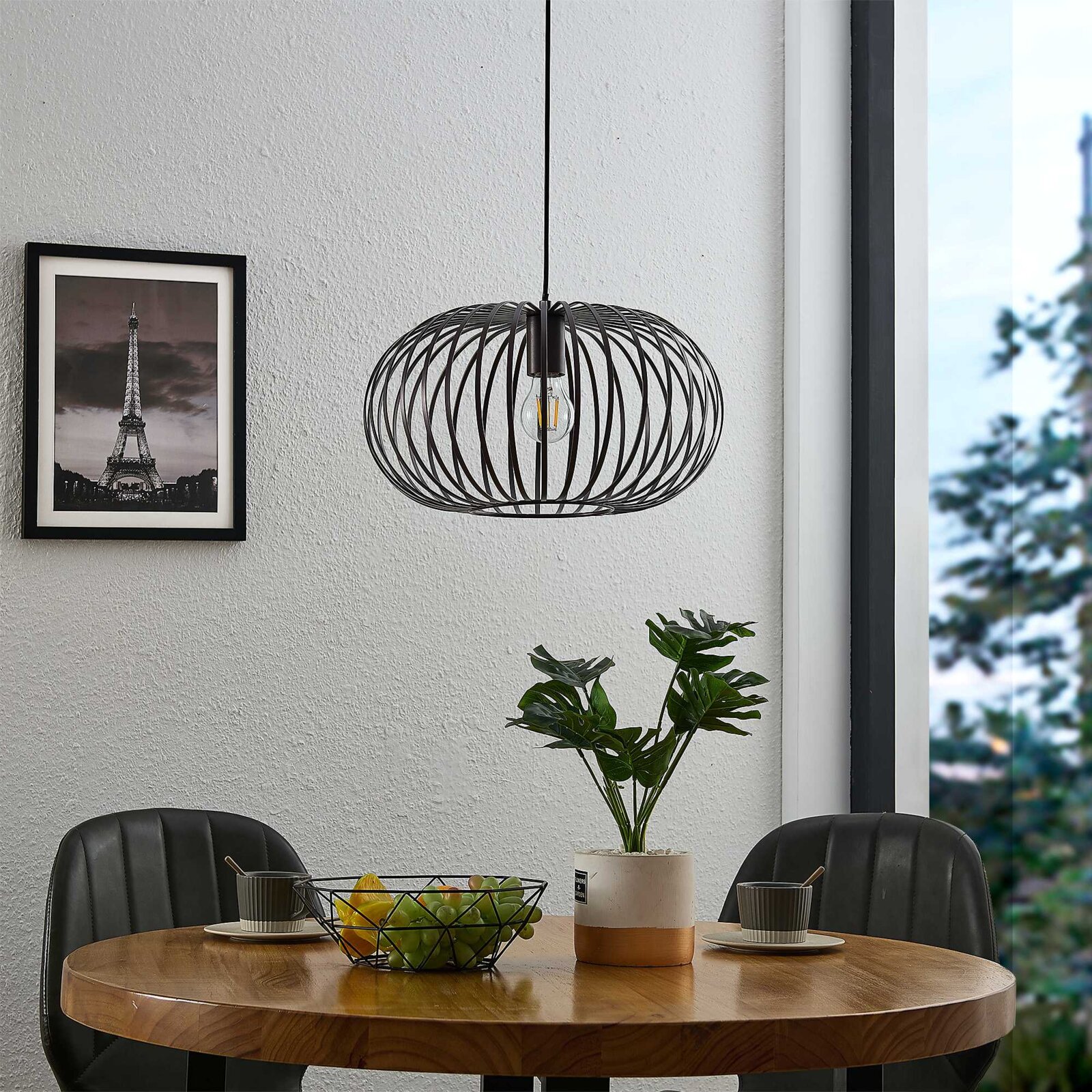 Novel Hanglamp FILTON Moderne hanglamp met een zwart, draadachtig ontwerp boven een eettafel, gezien vanaf de zijkant.