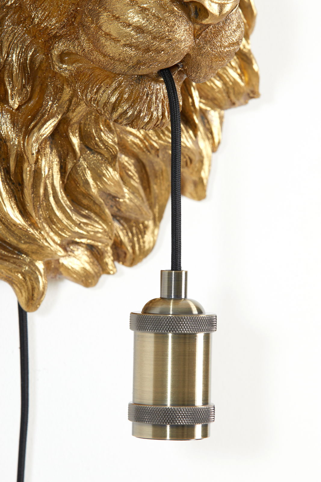 Detailansicht einer goldenen Löwenkopf-Wandleuchte mit einem schwarzen Kabel und einer bronzefarbenen Lampenfassung.