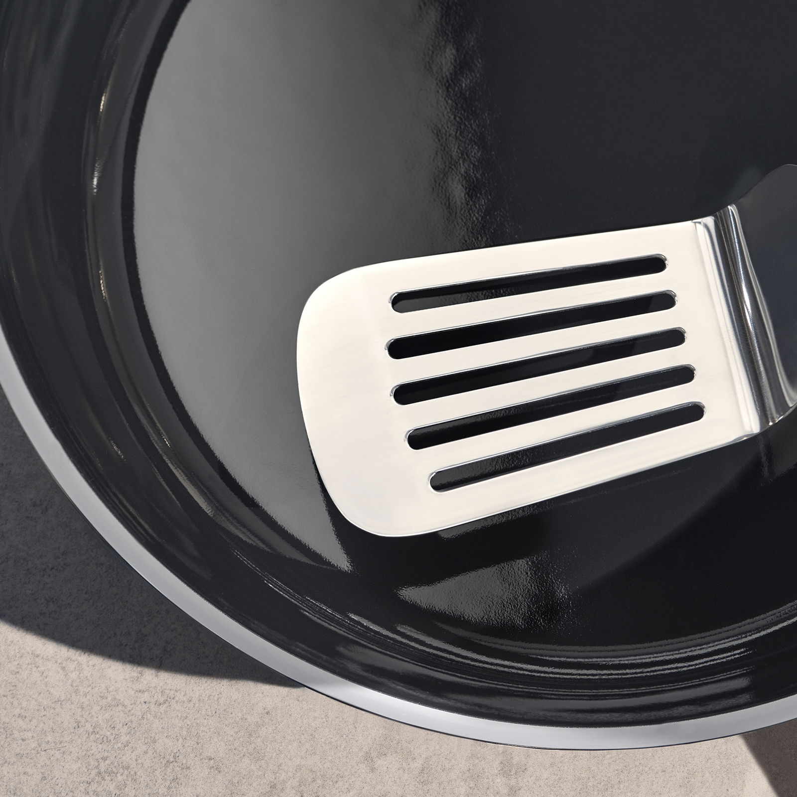 WMF Pfanne Ø24cm FUSIONTEC MINERAL PRO Nahaufnahme einer schwarzen Pfanne mit einem silbernen Pfannenwender, von oben betrachtet.