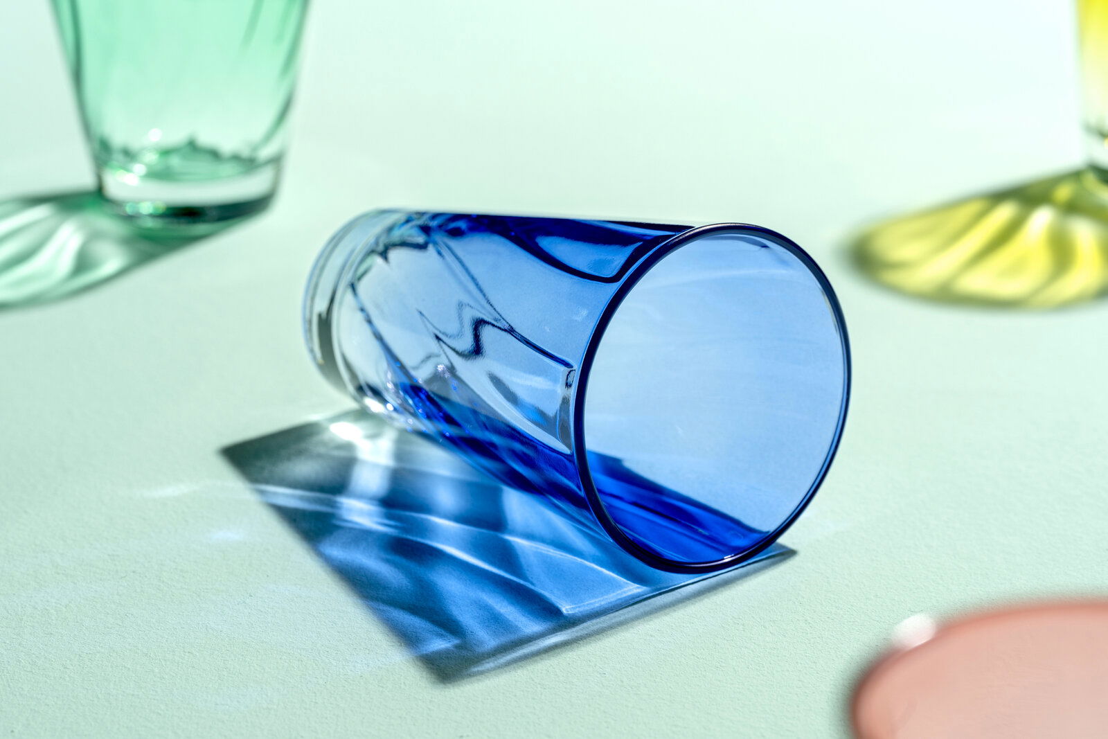 Blaues Trinkglas Twist mit 300ml Fassungsvermögen, liegend auf einer hellen Oberfläche, seitliche Perspektive