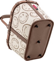 Reisenthel Tasche/Korb aus cremefarbenem Teddyfleece mit Smiley-Muster, braunen Gurten und Rahmen sowie Standfüßen, schräg von unten/seitlich (Bodenansicht) fotografiert