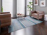 Moderner Designer Teppich in einem stilvollen Wohnzimmer mit braunen Ledersesseln und einem Couchtisch, aus der Perspektive von oben betrachtet.