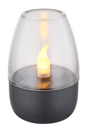 Nahaufnahme einer Solarleuchte mit flammenförmigem LED-Licht in einem transparenten Gehäuse auf einem dunklen Sockel.