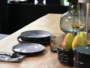 Elegantes Tellerset 18-tlg. Frost auf einem gedeckten Tisch, seitliche Perspektive