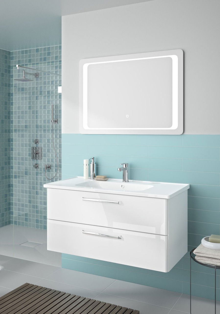 Moderner Badblock mit zwei Schubladen und integriertem Waschbecken, frontal betrachtet, vor einer Wand mit blauen Fliesen.