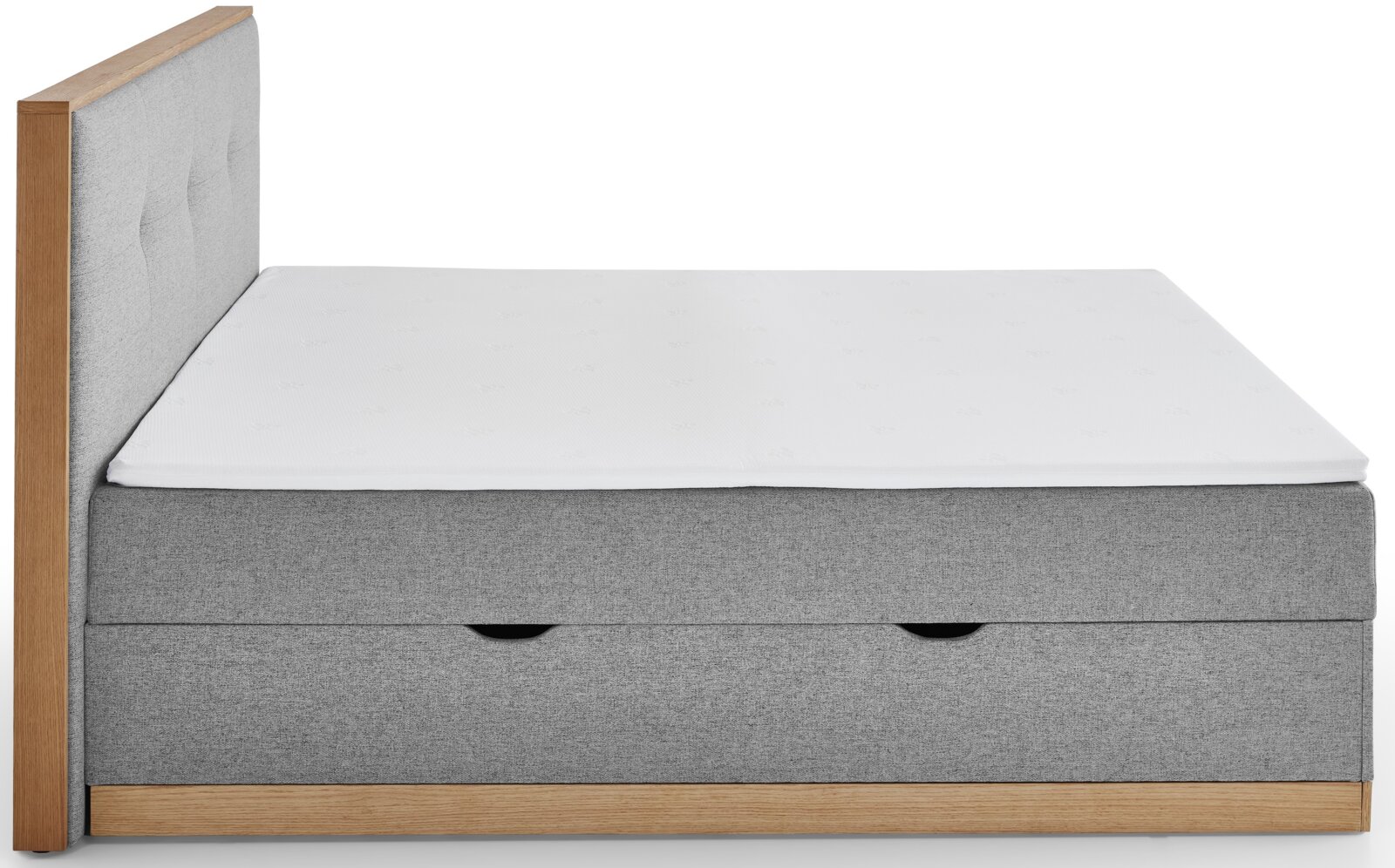 Zijaanzicht van een grijs boxbed met houten frame en wit matras.
