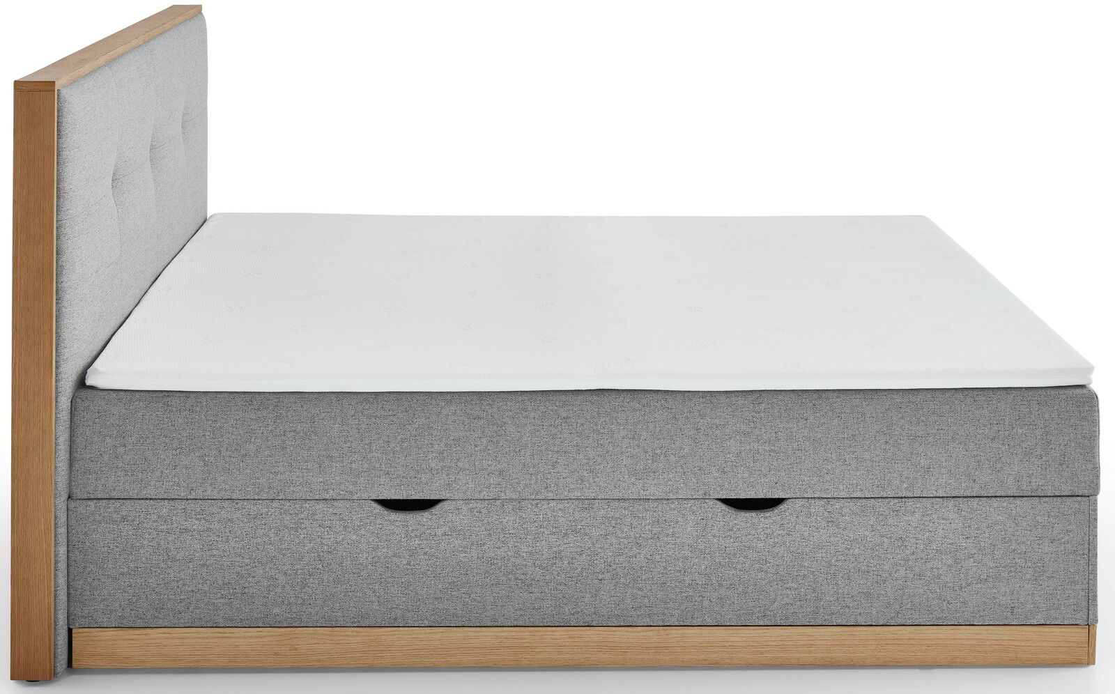 Seitenansicht eines grauen Boxbetts mit Holzrahmen und weißer Matratze.