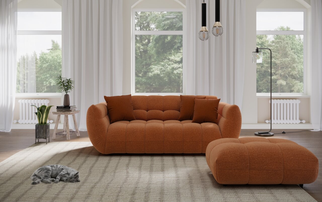 Lounge Handmade Big Sofa PANDA Gemütliches Big-Sofa in warmem Orange, frontal fotografiert, mit passendem Hocker in einem hellen, modernen Wohnzimmer.