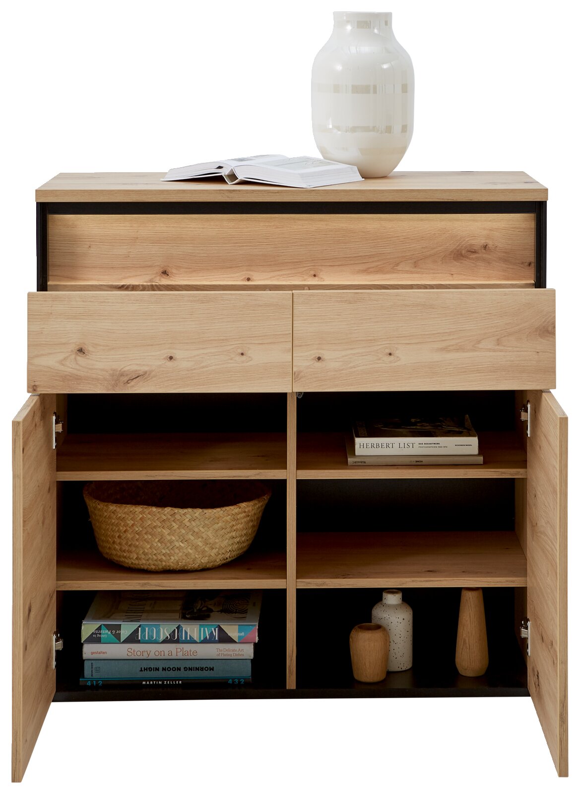 Houten ladekast met twee open lades en twee open deuren, waarin diverse voorwerpen zoals boeken, manden en decoraties te zien zijn. Vooraanzicht.