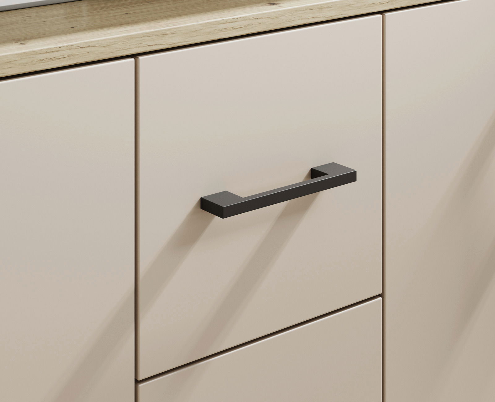 Nahaufnahme eines Sideboards mit cremefarbenen Türen und schwarzem Griff, aus seitlicher Perspektive.