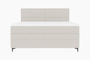 Frontale Ansicht eines modernen Boxspringbetts in hellem Stoffbezug mit schlichtem Design und schwarzen Füßen.