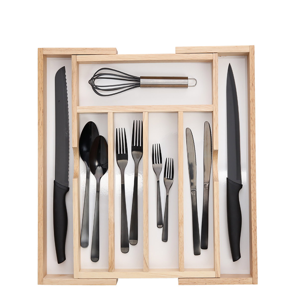 Vogelperspektive auf einen ausziehbaren Besteckkasten mit schwarzem Besteck und Küchenutensilien.
