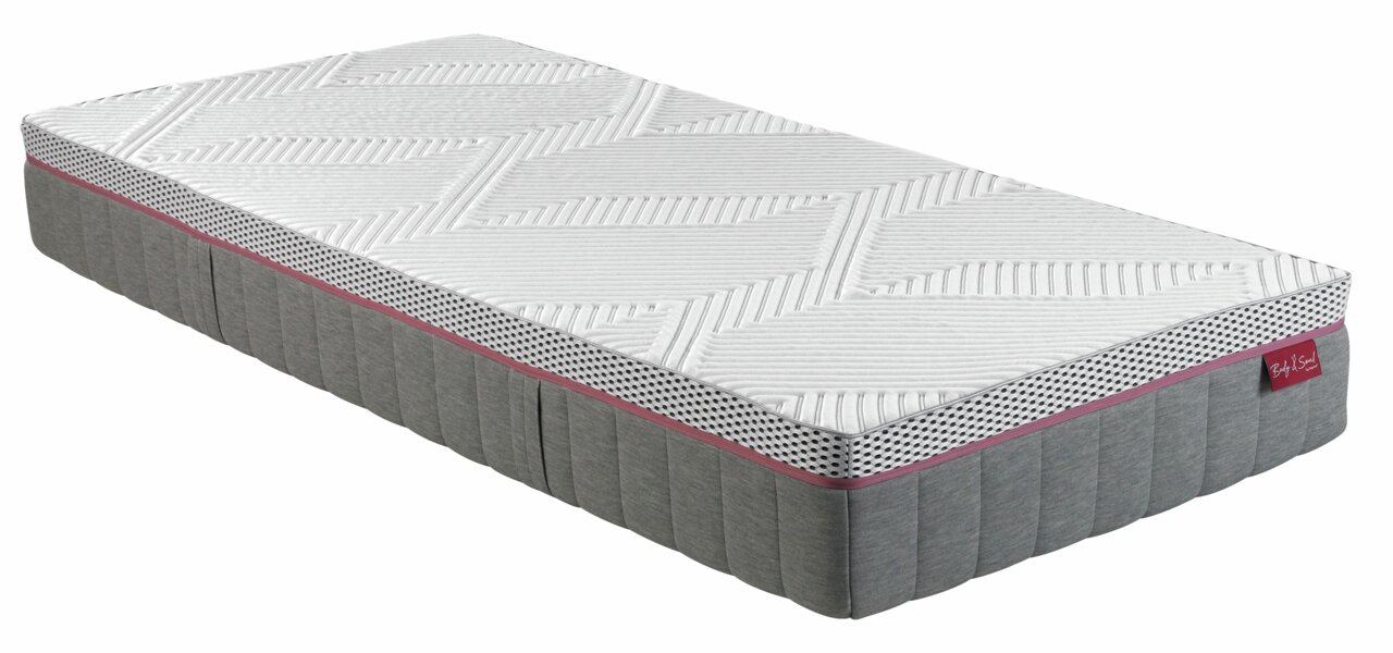 Matratze 90x200 MEDIUM in seitlicher Perspektive mit grauem und weißem Design, gepunktetem Rand und rotem Etikett.