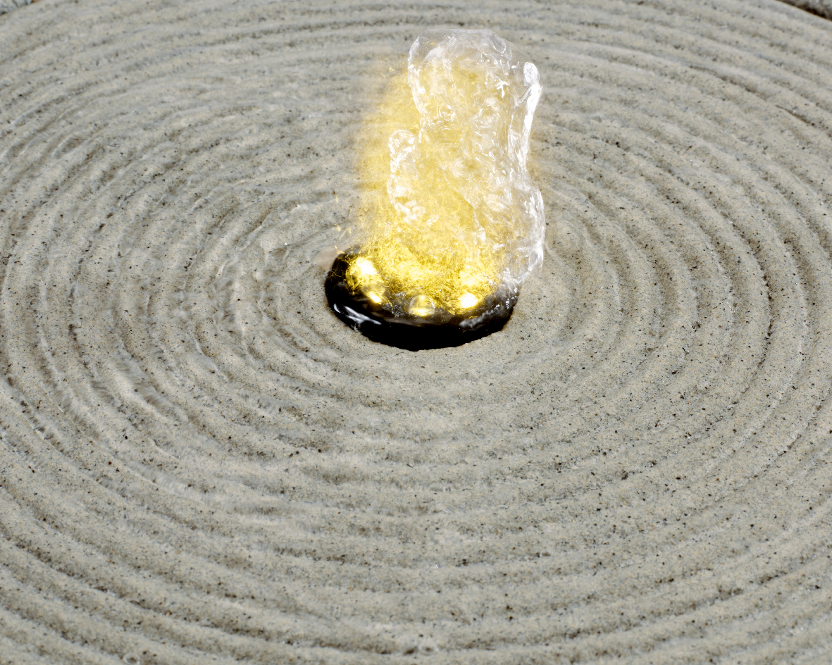 Vogelperspektive auf einen sprudelnden Brunnen aus recyceltem Kunststoff mit konzentrischen Kreisen im Wasser.