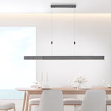 Moderne LED-Pendelleuchte PURE MOTO in minimalistischem Design, hängend über einem Esstisch, seitliche Perspektive.