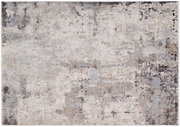 Moderner Designer-Teppich in abstraktem Muster mit neutralen Farbtönen, aus der Vogelperspektive fotografiert.