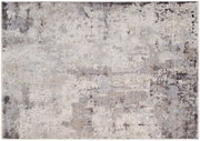 Moderner Designer-Teppich in abstraktem Muster mit neutralen Farbtönen, aus der Vogelperspektive fotografiert.