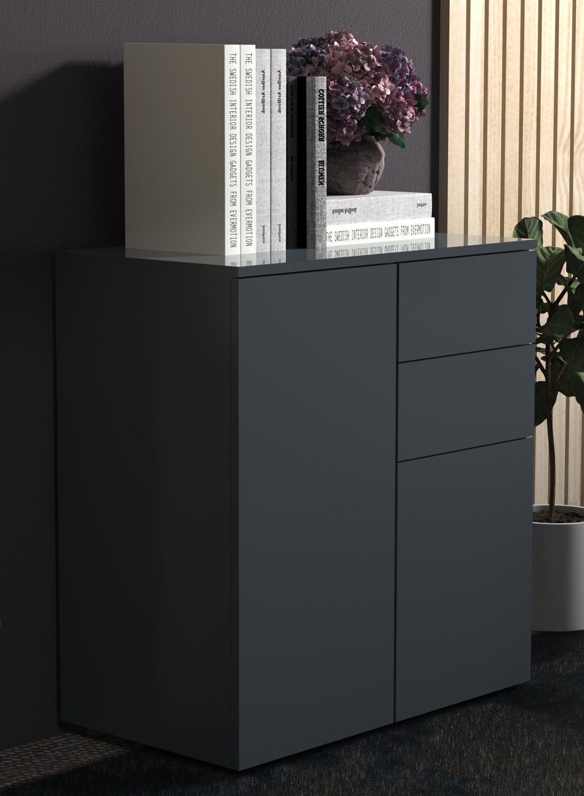 Moderne dunkelgraue Kommode mit glatter Front und Schubladen, auf der Glasplatte stehen Bücher und eine Hortensie im Topf; Ansicht schräg von vorne rechts in Innenraum-Szene