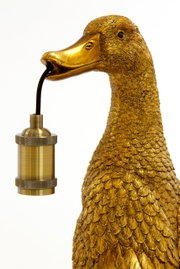 Goldene Tischleuchte in Form einer Ente, die eine Glühbirnenfassung im Schnabel hält. Seitenansicht.