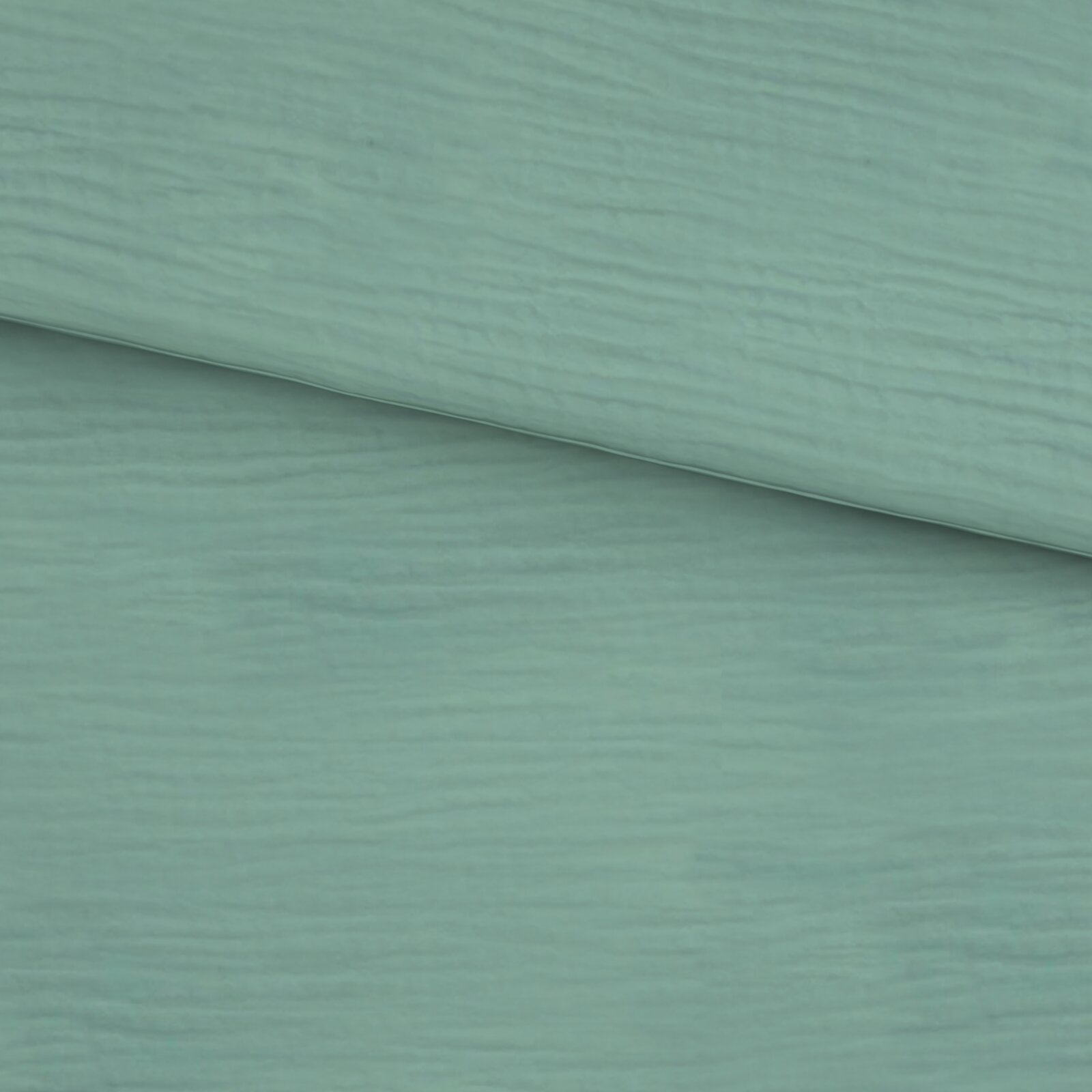 Nahaufnahme einer mintgrünen Holzoptik-Oberfläche mit feiner Maserung, schräg von oben fotografiert; zwei Paneele/Platten überlappen sich diagonal.