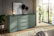Modernes Sideboard in einem hellen Raum mit Pflanzen und großen Fenstern, seitliche Perspektive