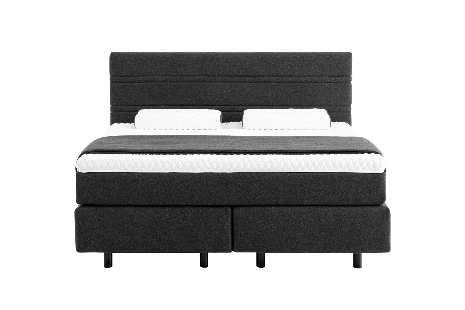 Boxspringbett in dunklem Stoffbezug mit zwei weißen Kissen, Frontalansicht