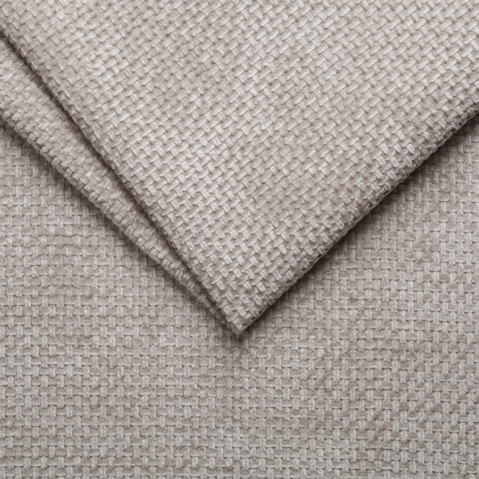 Nahaufnahme eines beigen, strukturierten Stoffes in diagonaler Perspektive, verwendet für ein Polsterbettgestell.