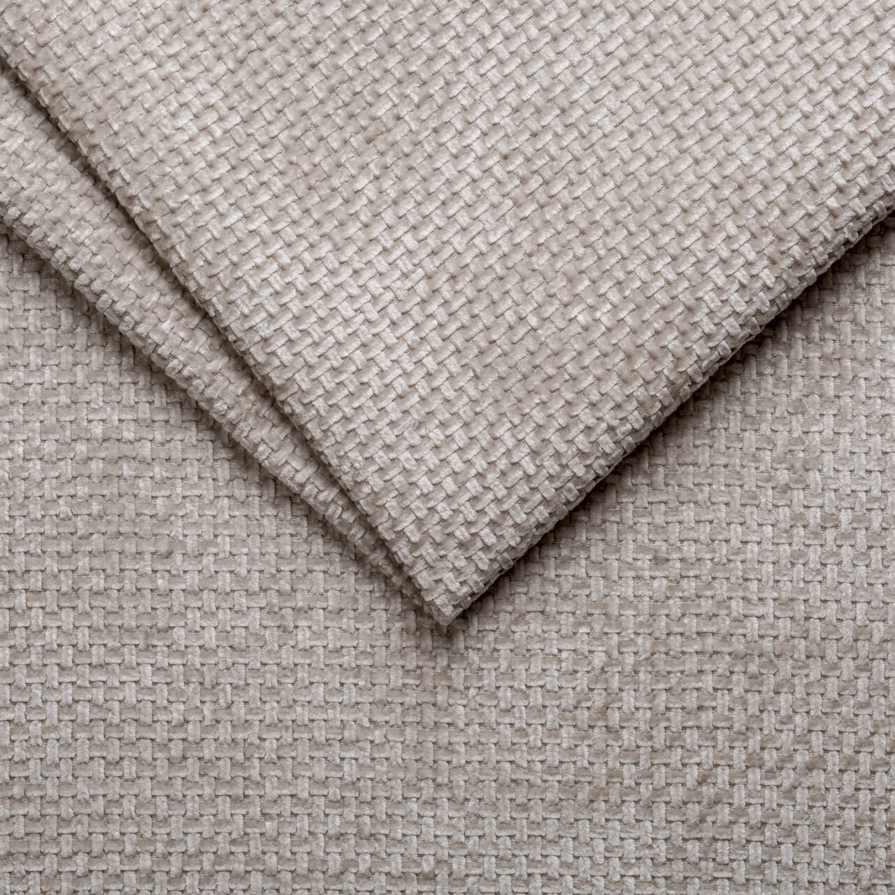 Nahaufnahme eines beigen, strukturierten Stoffes in diagonaler Perspektive, verwendet für ein Polsterbettgestell.