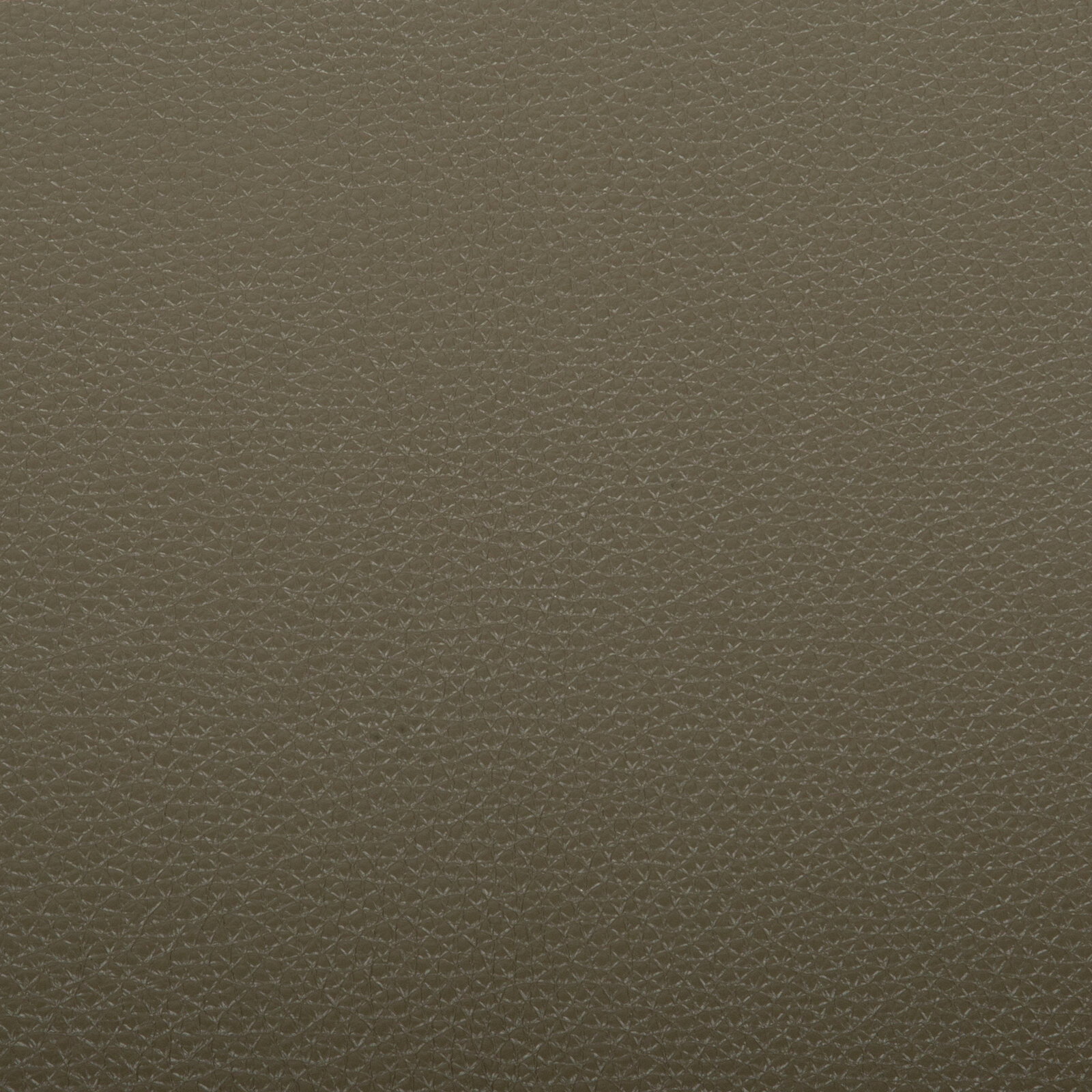 Makroaufnahme in Draufsicht einer braun-oliven, fein strukturierten Oberfläche mit geometrischem Muster (Material-Textur)