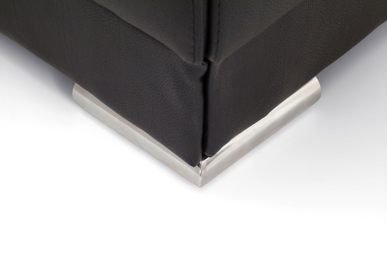 Nahaufnahme eines schwarzen Polsterbettes mit silbernem Metallfuß, Perspektive von unten.