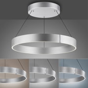 Moderne hanglamp PURE E-CLIPSE van Paul Neuhaus in de vorm van een zilveren ring, gezien van onderaf, met verschillende achtergrondkleuren.