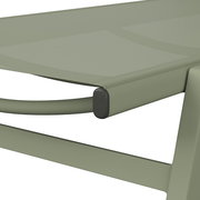 Nahaufnahme einer grünen Sonnenliege mit modernem Design, seitliche Perspektive