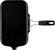 Zwarte Le Creuset grillpan met geribbelde bakplaat en handvat, bovenaanzicht (van boven gefotografeerd) op witte achtergrond