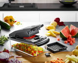 Würfel- und Stifteschneider Treppo in einer modernen Küche, seitliche Perspektive, umgeben von geschnittenem Gemüse und Obst.