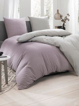 Bettwäsche-Set in sanften Pastelltönen auf einem Bett, seitliche Perspektive