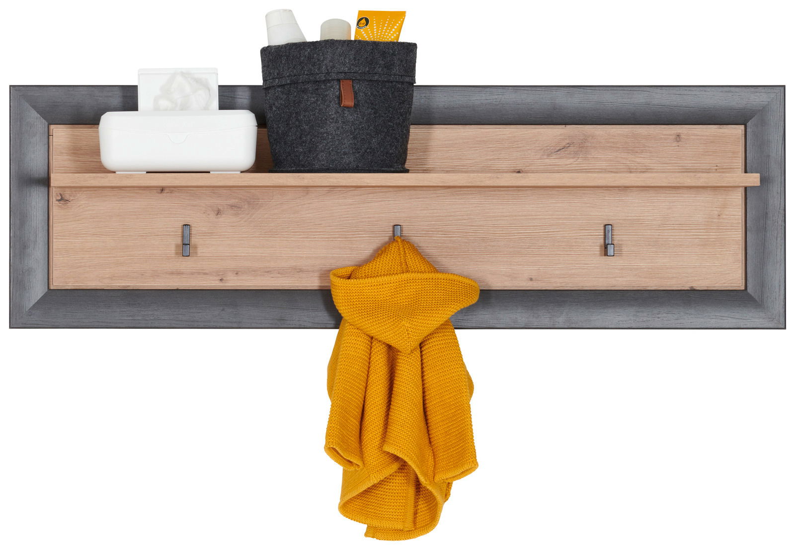 Wandboard mit grauem Rahmen und Holzelementen, ausgestattet mit Haken und Ablage, frontal fotografiert.