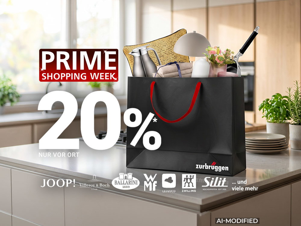 Einkaufstasche von Zurbrüggen mit Wohnaccessoires und Markenartikeln auf moderner Kücheninsel zur Prime Shopping Week.